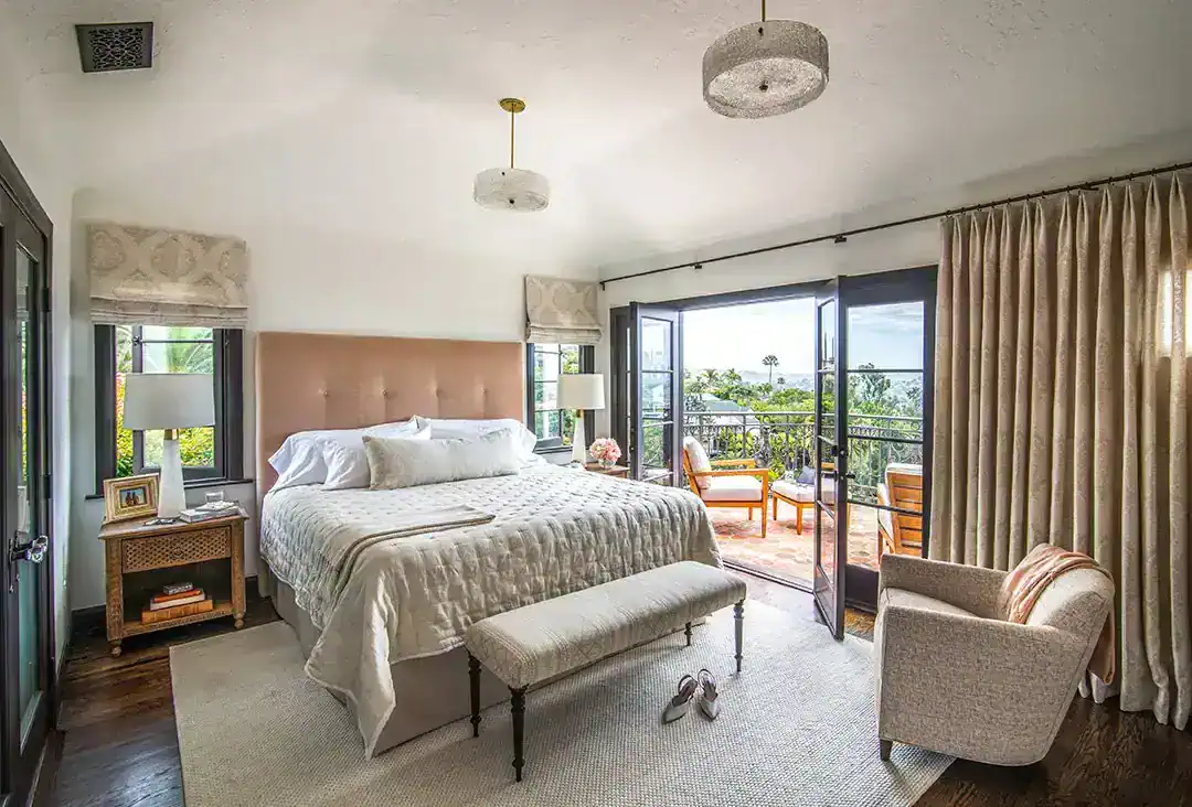  The primary bed headboard is covered in a neutral mohair by Janet Yonaty, the bench is from1st Dibs. Photos by  Nolasco Studios.  