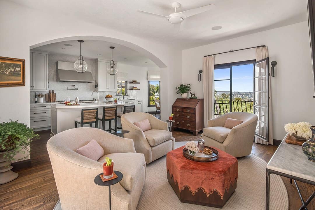  In the family room, three swivel club chairs and the ottoman are custom, the treatments are by Valley Drapery and the rug is by Patterson Flynn & Martin. Photos by  Nolasco Studios.  