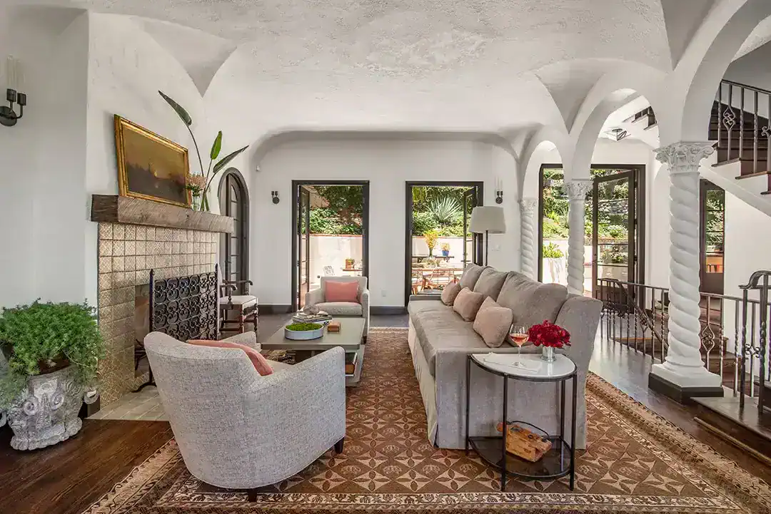  In the living room, the custom sofa is covered in Schumacher chenille, the club chairs are by A.Rudin and the coffee table was found on 1st Dibs. Photos by  Nolasco Studios.  
