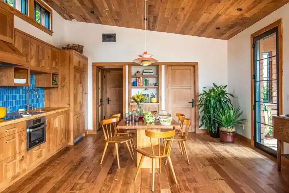   Reclaimed wood from the original shed was used on the floors and ceiling in the common area.   
